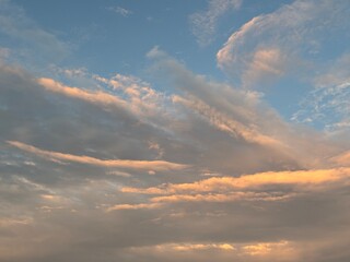 calm sky photo with soft and thin clouds golden light of the sun, light and shadow on the clouds create texture, bright blue sky calming background. Suitable for nature, tranquility, weather, freedom