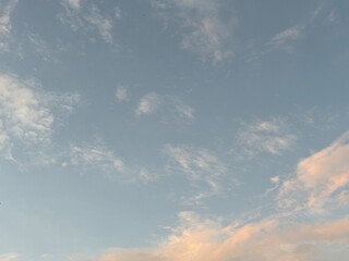 calm sky photo with soft and thin clouds golden light of the sun, light and shadow on the clouds create texture, bright blue sky calming background. Suitable for nature, tranquility, weather, freedom