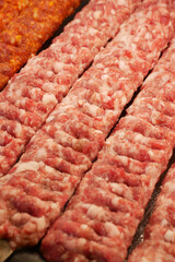 Freshly prepared meat strips for grilling at local market