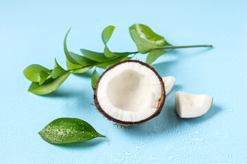 Fresh coconut and leaves on blue background