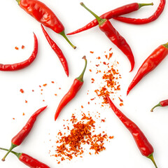 n artistic arrangement of red chili peppers and crushed chili flakes scattered on a white background. showcasing the vibrant colors and textures of the ingredients this composition emphasizes culinary