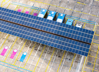 Aerial view above innovative solar panels located on a bus parking lot rooftops