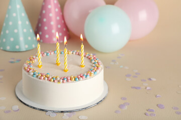 Tasty Birthday cake on beige background