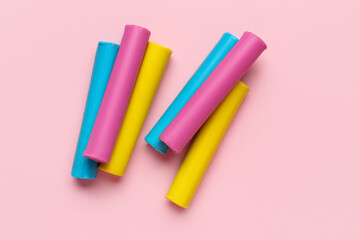 Colorful plasticine on pink background