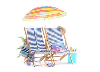 Striped deck chairs with colorful beach umbrella and travelling accessories isolated on white...