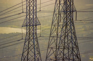 High voltage power lines and transmission towers at sunset