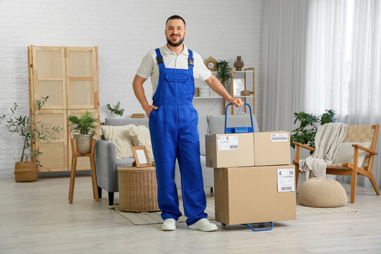 Delivery man with parcel boxes in room