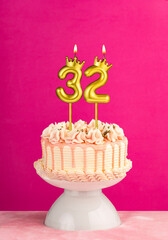 Number 32 birthday candle - Pink celebration cake with drip icing