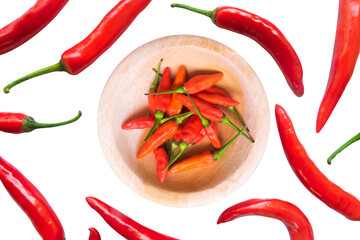 arrangement of spicy red chili peppers with a wooden bowl in the center