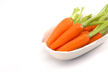 Organic mini carrots isolated on white background.