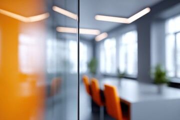 Modern office interior with blurred background in soft gray tones, featuring glass partitions, panoramic windows and bright orange accents for a contemporary business workspace look