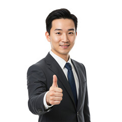 Confident young Asian businessman in a dark formal suit and tie, smiling and giving a thumbs up gesture of approval. Isolated on a transparent background, studio portrait.