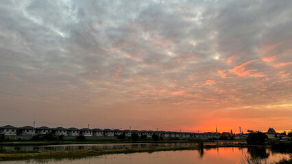 Scenic View of a Quiet Village at Dusk, Gently Bathed in the Warm Golden Light of the Setting Sun