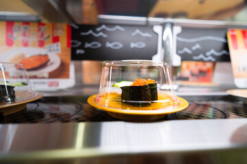 Sushi food in Asian Japanese restaurants is delivered by conveyor belt