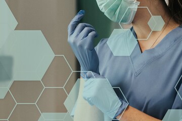 Doctor putting on a glove to prevent coronavirus contamination
