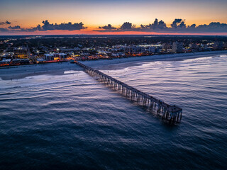 Aerial view of the Jacksonville Beach Pier in north Florida at dusk.