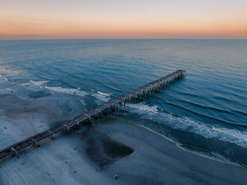 Aerial view of the Jacksonville Beach Pier in north Florida at dusk.