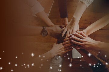 Hands joined over wooden table