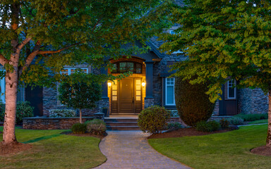 Entrance of luxury house with nice spring blossom landscape at night in Vancouver, Canada, North America. May 2025.