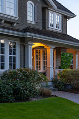 Entrance of luxury house with nice spring blossom landscape at night in Vancouver, Canada, North America. May 2025.