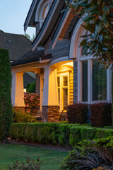 Entrance of luxury house with nice spring blossom landscape at night in Vancouver, Canada, North America. May 2025.
