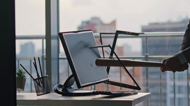 Unknown businessman smashing computer screen using bat inside office closeup