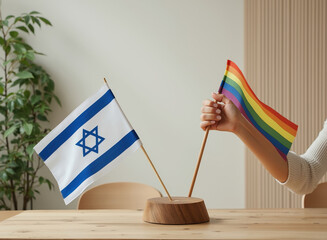 person holds a rainbow flag alongside a Jewish flag on a wooden stand.