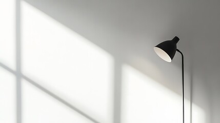 Simple floor lamp against a white wall with window shadows.