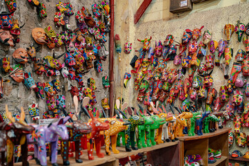 Guatemalan artisan masks and wooden figurines resembling alebrijes