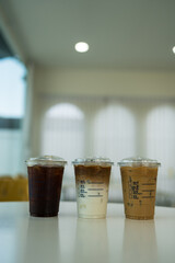 Glasses of iced coffee drinks on table. Iced americano, iced latte and iced mocha