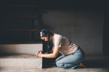 Female kneeling down praying for worship God at home. Christians pray to jesus christ for calmness....