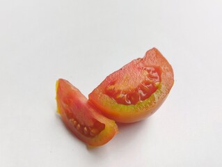 Two slices of cut out tomato isolated on white background.