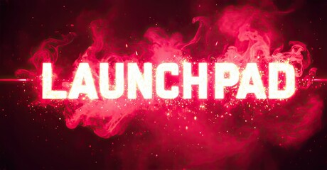 Bright text spells LAUNCHPAD against vibrant pink smoke, dark background. Dramatic lighting creates intense visual impact.