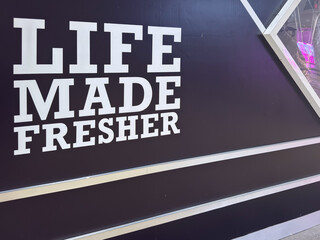 Life made fresher sign on black background showcasing brand message