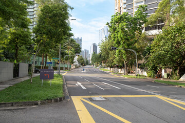 Orchard Road street view with lush greenery and urban skyline backdrop
