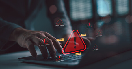 Cybersecurity threat and system warning alert concept. Hands typing on a laptop with multiple...