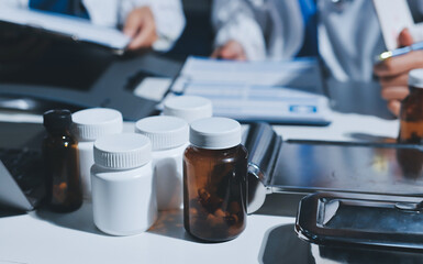 Male and female doctors are having a meeting in a hospital room.