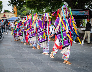 Vibrant costumes and masks in Danza de los Viejitos performance in Mexico
