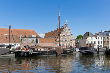 Historic Leiden, Holland: Classic wooden ships moored along the serene Galgewater canal, framed by charming traditional Dutch architecture under a clear blue sky. Leiden, Netherlands, 3 May 2025.