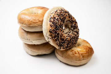 Closeup view of stack collection of bagel breads with various kind isolated over white background