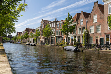 Picturesque Oude Rijn canal in Leiden, lined with charming historic Dutch houses and leafy trees...
