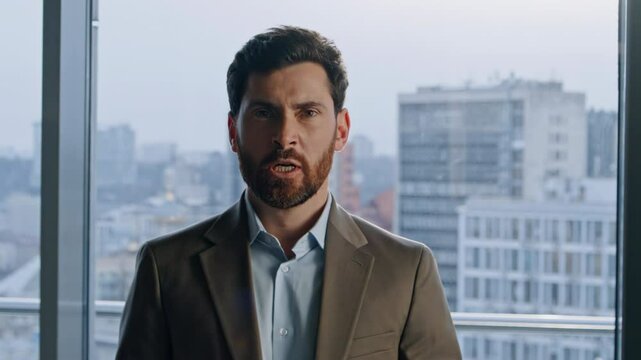 Portrait angry boss gesturing hands at panoramic office. Man screaming loudly 