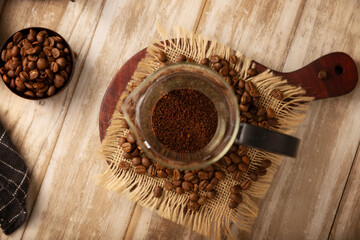 Roasted and ground coffee in a French press..French press, also known as a piston coffee maker or French coffeemaker, is a simple device for preparing hot coffee.