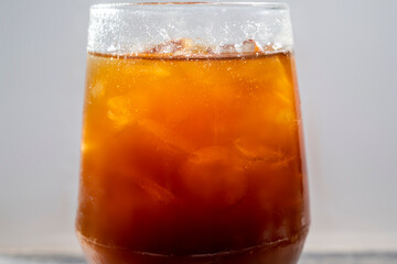 Closeup view of cold brew coffee in a glass on the table
