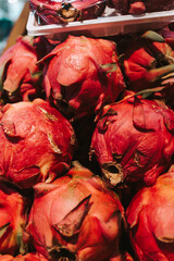 Ripe pitahaya on a supermarket counter close-up. Exotic fruits in the store