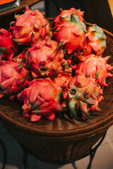 Red ripe pitahaya in a basket near the counters in the supermarket. Delicious exotic fruits in the grocery store.