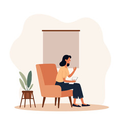 Fototapeta premium A young woman is sitting on a couch at creative work space