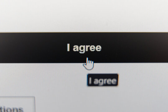 Close-up of a computer screen showing a cursor clicking on an I agree button for terms and conditions