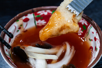 dipping fried pork into sweet sauce