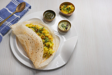 Crispy Masala dosa is a popular South Indian food item served with tomato chutney, coconut chutney,...